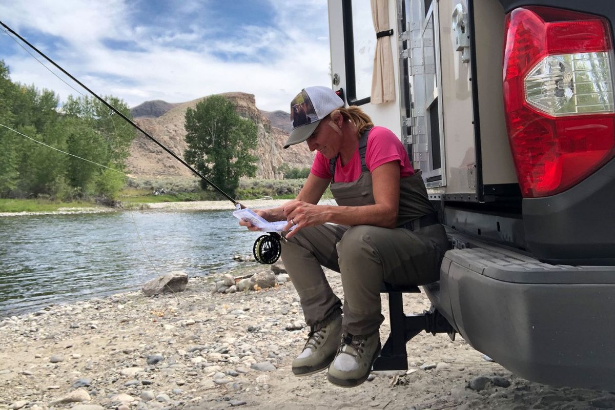 Kris Millgate fishes on the Salmon River as she follows chinook salmon migrating from the ocean to central Idaho during her Ocean to Idaho project. Millgate’s left ear is patched up after some skin cancer was removed this summer. (Kris Milgate/courtesy)