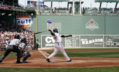Boston Red Sox’s David Ortiz follows through on his first-inning home run. Ortiz also singled in the game-tying run in the seventh. (Associated Press / The Spokesman-Review)