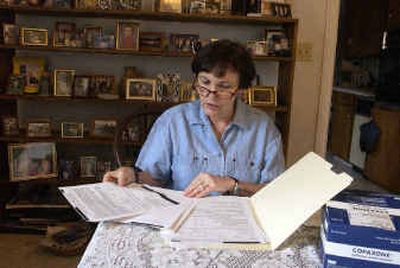 
Rita Callery, of Lewiston, sorts through her entry in a Medicare lottery to win prescription benefits. She takes Copaxone for multiple sclerosis. A month's supply costs more than $1,000.
 (Jesse Tinsley / The Spokesman-Review)