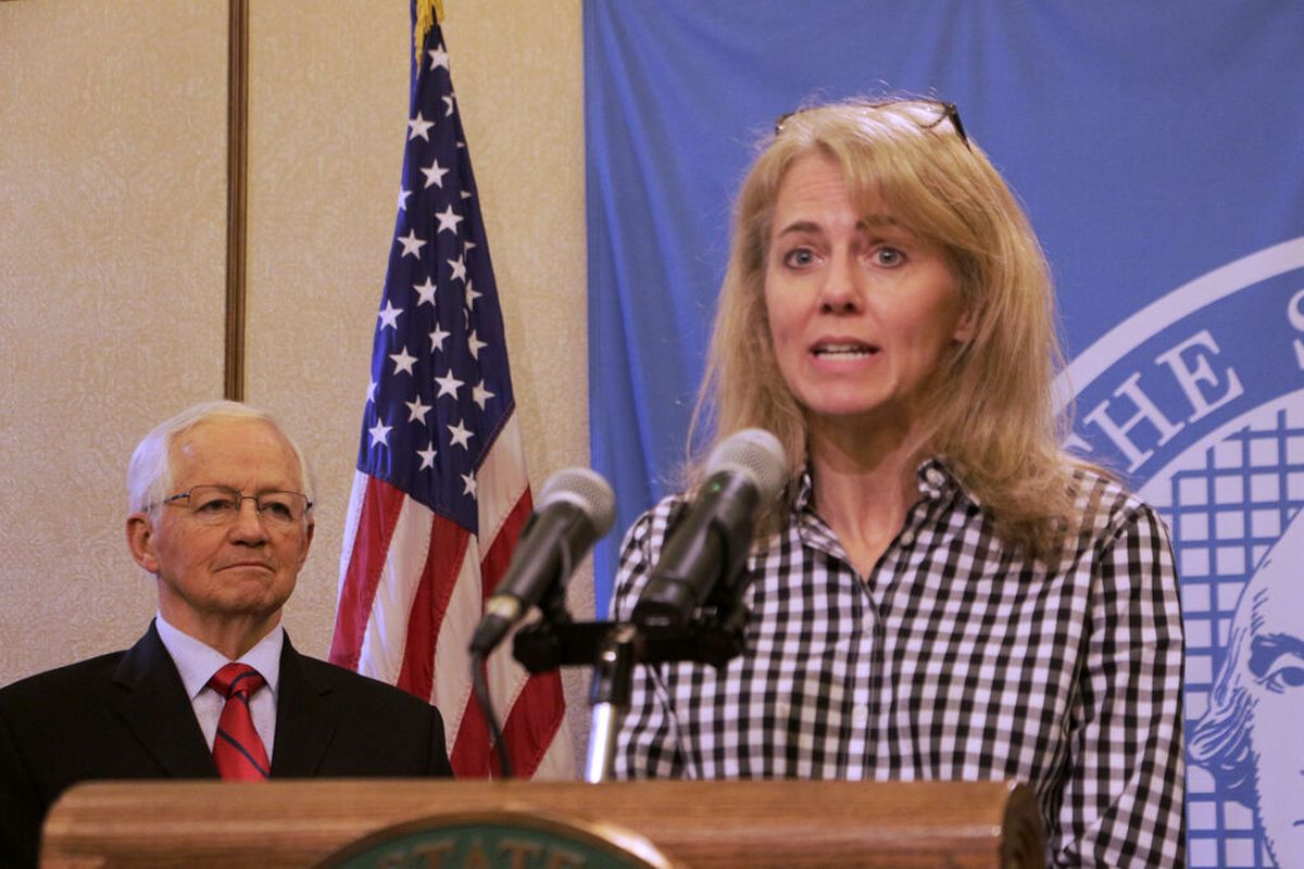 State Health Officer Dr. Kathy Lofy speaks to the press about the coronavirus outbreak, as Insurance Commissioner Mike Kriedler looks on in this photo from March.  (Rachel La Corte)
