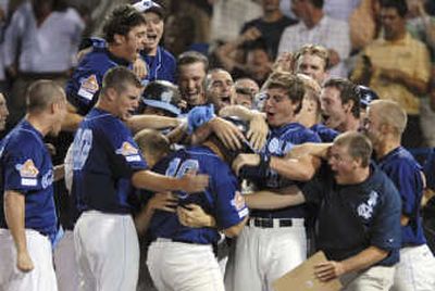 
North Carolina players mob Tim Federowicz, center, after he hit a grand slam against LSU in the ninth inning. Associated Press
 (Associated Press / The Spokesman-Review)