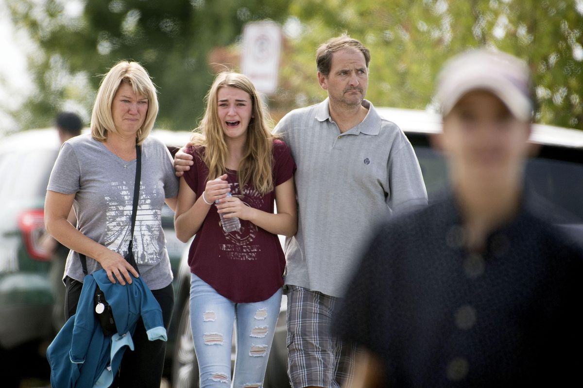 Parents, reunited with their children, leave Freeman High School hours after a school shooting left one student dead and three injured, Wed. Sep 13, 2017, in rural Spokane County. COLIN MULVANY colinm@spokesman.com (Colin Mulvany / The Spokesman-Review)