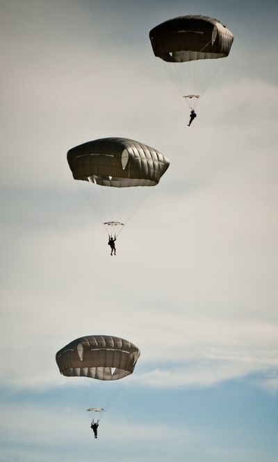 In this 2009 photo, paratroopers from Fort Bragg using the Army’s new T-11 parachute float to a drop zone after jumping from a C-17 aircraft. (Associated Press)