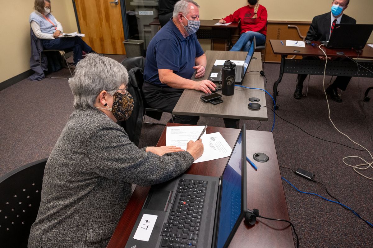 During a canvassing board meeting, Spokane County Auditor Vicky Dalton, Spokane County Commissioner Al French and Spokane County Prosecuting Attorney Larry Haskell sign a document certifying this year’s election results Tuesday at the Elections Office.  (Colin Mulvany/THE SPOKESMAN-REVIEW)