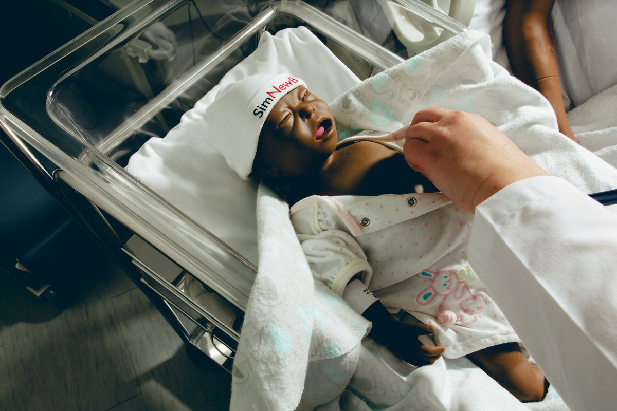A nursing student trains with a baby manikin at Seton Hall University’s Interprofessional Health Sciences Campus on Feb. 13 in Nutley, N.J. Medical manikins help health care workers learn how to handle fast-changing and complex scenarios.  (AMIR HAMJA)