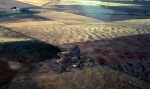 Giant current ripples  southwest of Fairchild Air Force Base  were produced during the catastrophic Ice Age outburst floods when  the ice dam containing Glacial Lake Missoula failed. (Courtesy Kiver / The Spokesman-Review)