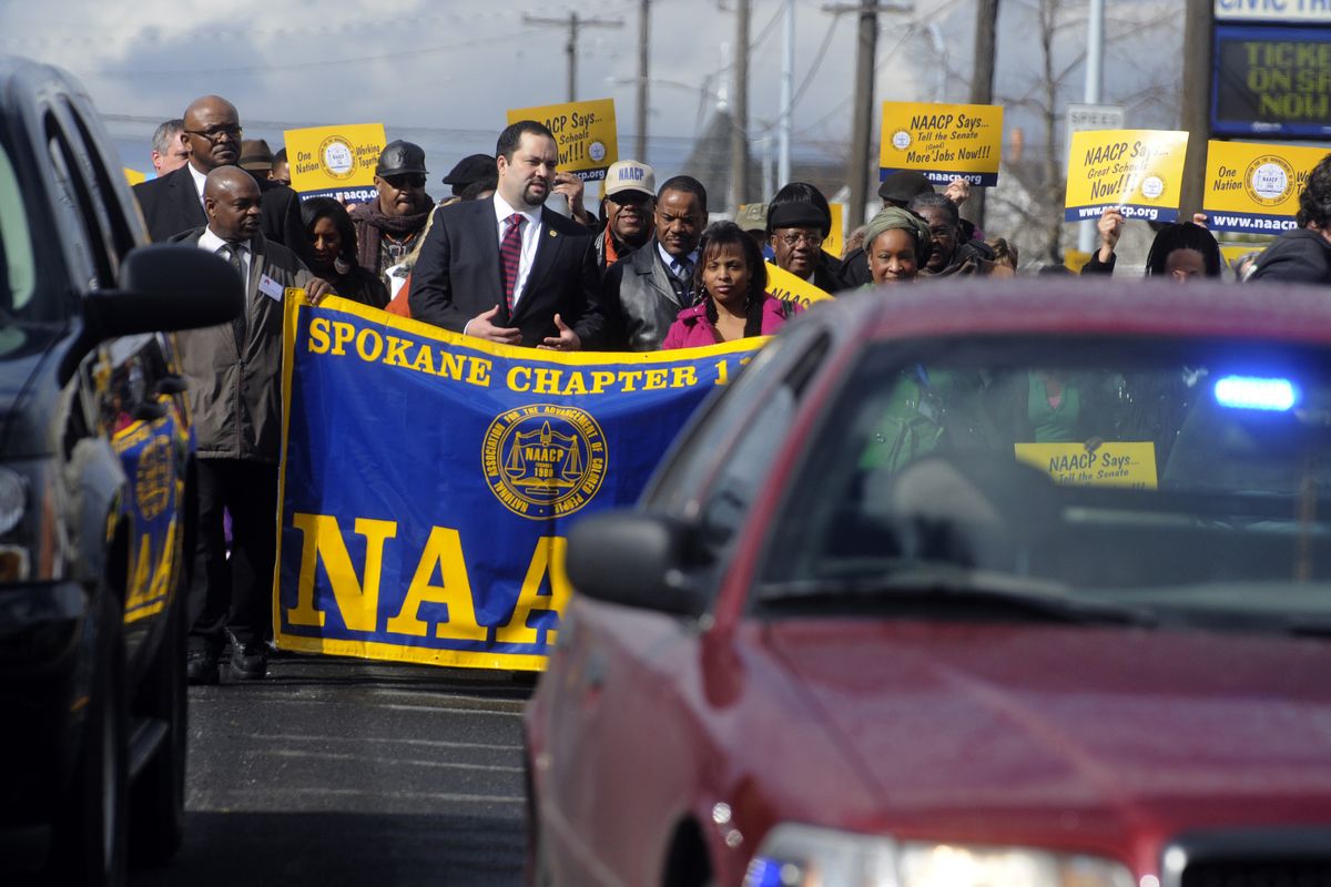 Security was tight as Benjamin Todd Jealous, president and CEO of the NAACP, led a march of several hundred people from Spokane Veterans Memorial Arena to the Lilac Bowl in Riverfront Park on Sunday. (J. Bart Rayniak)