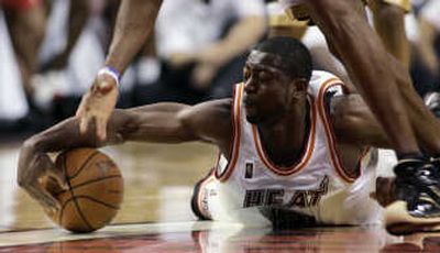 
Associated Press Miami's Dwyane Wade scrambles for a loose ball on Thursday night.
 (Associated Press / The Spokesman-Review)