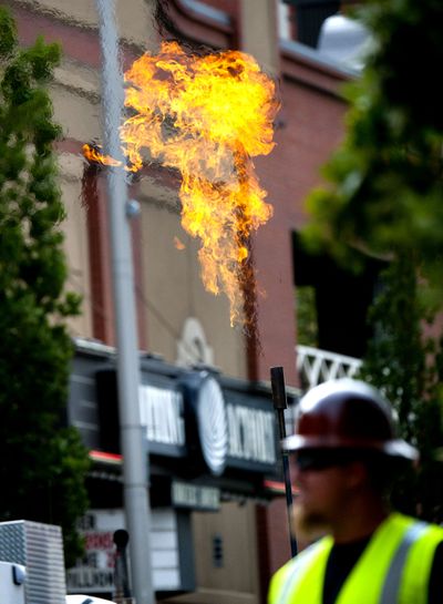 Avista Utilities conducted a natural gas burn-off after a Spokane crew hit a 12-inch gas main at Sprague Avenue and Monroe Street on Monday. (Kathy Plonka)