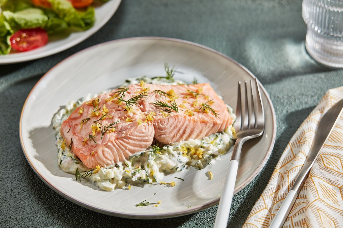 This poached salmon is served with a yogurt sauce that is similar to tzatziki but made with zucchini instead of cucumber.  (Tom McCorkle for The Washington Post)