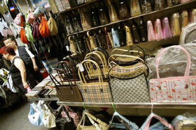 
Handbags with qualities resembling high-end fashion brands are sold at a Hong Kong market on Tung Choi Street last month. 
 (Associated Press / The Spokesman-Review)