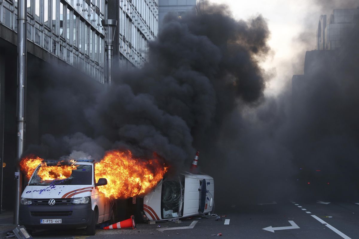 Demonstrators light a police van on fire during a protest of the yellow jackets in Brussels, on Friday, Nov. 30, 2018. The demonstrators are protesting against rising fuel prices. (Francisco Seco / AP)