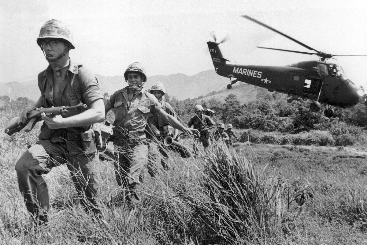 In this April 28, 1965 file photo, U.S. Marine infantry stream into a suspected Viet Cong village near Da Nang in Vietnam during the Vietnamese war. Filmmaker Ken Burns said he hopes his 10-part documentary about the War, which begins Sept. 17, 2017 on PBS, could serve as sort of a vaccine against some problems that took root during the conflict, such as a lack of civil discourse in America. (Eddie Adams / AP)