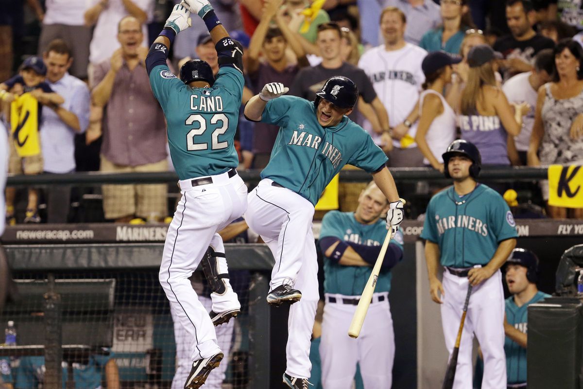 Seattle’s Robinson Cano, left, and Kyle Seager do the bump after Cano’s solo home run in the sixth inning on Monday. (Associated Press)
