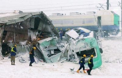 
Rescuers examine cars of an express train after its derailment today in Shonai, northern Japan,  killing four people and injuring more than 30. 
 (Associated Press / The Spokesman-Review)