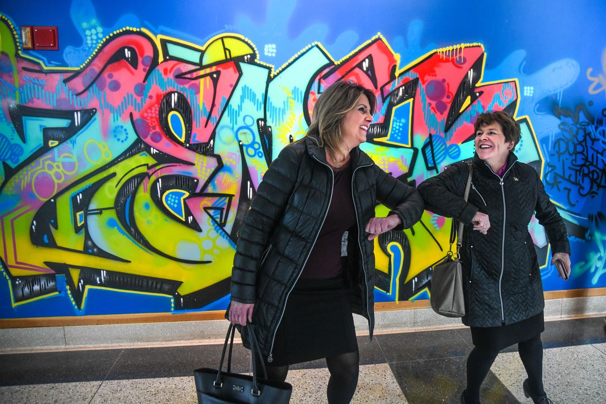 Spokane Mayor Nadine Woodward, left, and Lisa Brown, who was then the Washington state Commerce Director, meet and greet before a tour of the temporary shelter for the homeless, on March 30, 2020, at the downtown Spokane Public Library. Brown announced last week that she would challenge Woodward