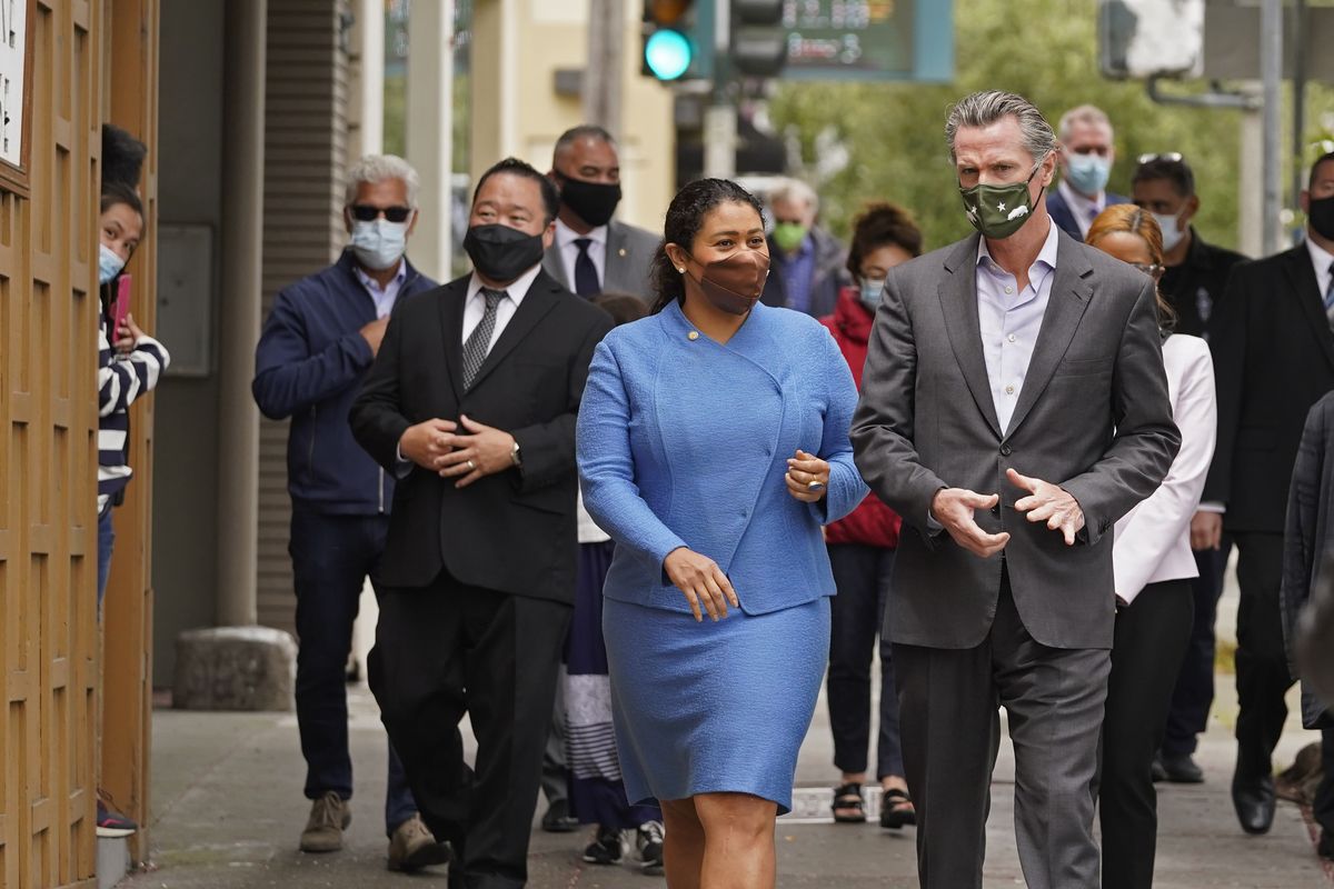 FILE - In this June 3, 2021 file photo California Gov. Gavin Newsom walks with San Francisco Mayor London Breed on Geary Street to a news conference outside Tommy