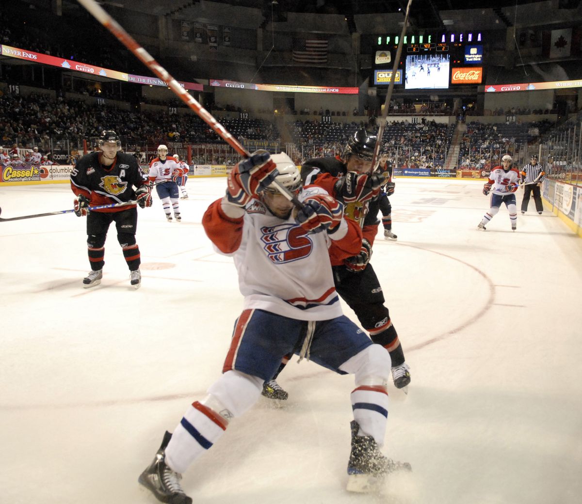 Chiefs right winger Ryan Letts chases down the puck in front of Prince George defenseman Colin Scherger in the first period. (J. Bart Rayniak / The Spokesman-Review)