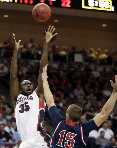 Gonzaga's Sam Dower Jr. shoots covered by Saint Mary's Beau Levesque during the first half of a West Coast Conference tournament NCAA college basketball game Monday. (Associated Press)