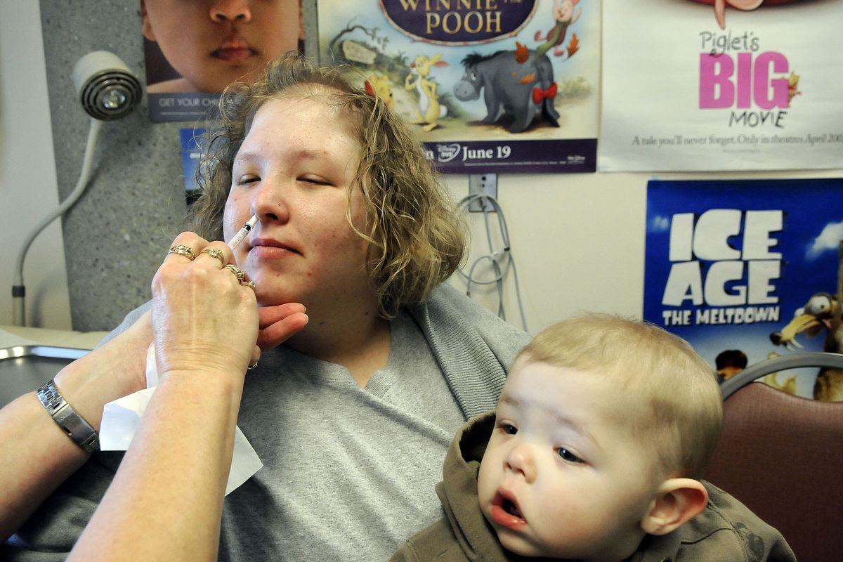 Holly Zenick, 25, receives an H1N1 nasal spray vaccination Oct. 21 at the Spokane Regional Health District office in Spokane. Zenick’s son, Brayden, 1, had a high-risk health condition.  (FILE)