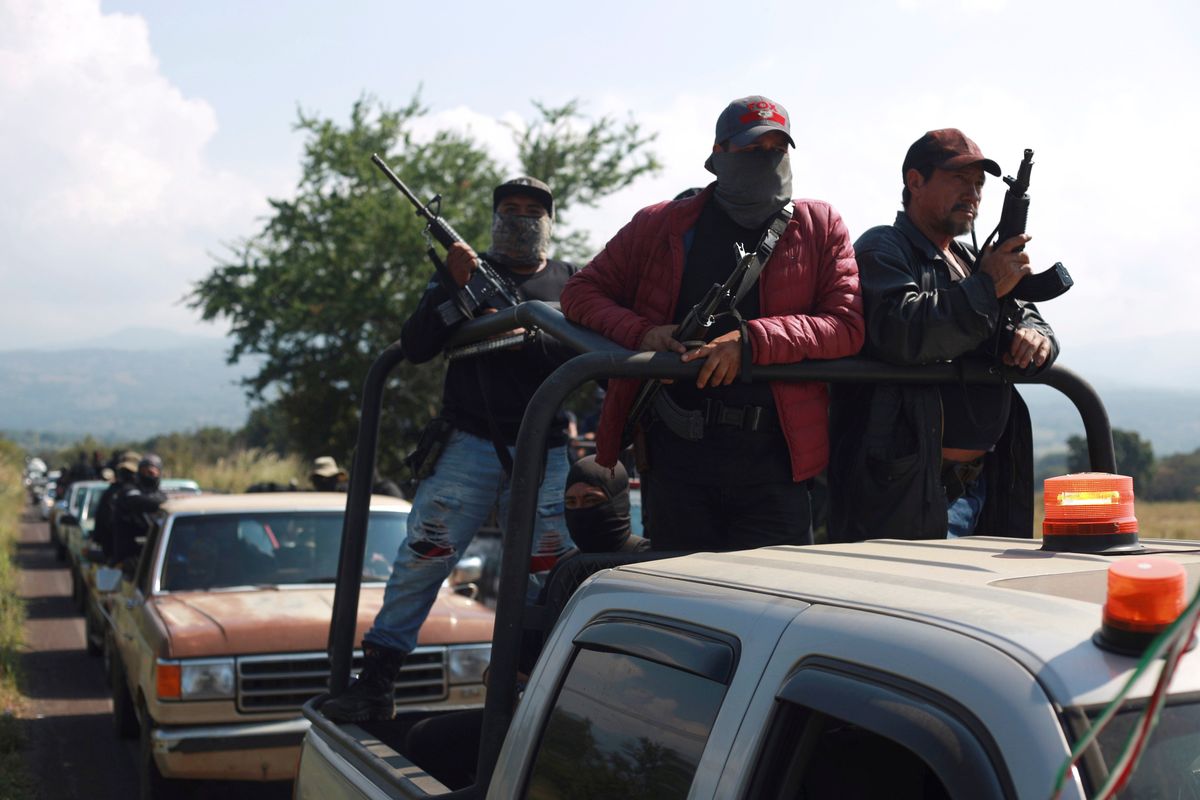 Members of the so-called self-defense group known as United Towns or Pueblos Unidos, gather for a rally Saturday in Nuevo Urecho, in the Mexican state of Michoacan.  (Armando Solis)