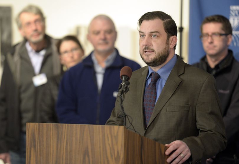 Spokane City Council President Ben Stuckart, surrounded by environmental and neighborhood advocates, delivers a terse rebuke of Mayor David Condon’s veto of an anti-sprawl ordinance Monday at City Hall. (Jesse Tinsley)