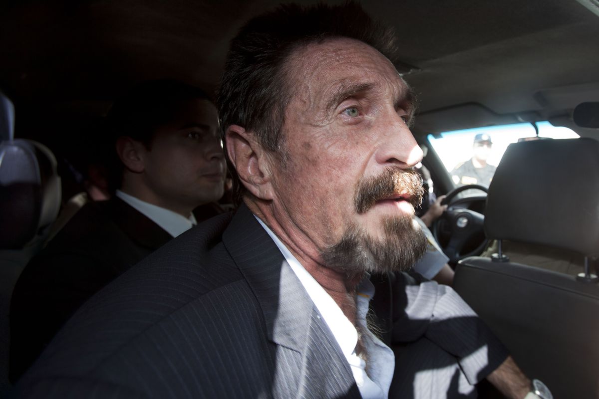 Software company founder John McAfee leaves an immigration detention center for the La Aurora international airport in Guatemala City, Wednesday Dec. 12, 2012. McAfee, who is being deported to the U.S., was detained last week for immigration violations after he sneaked into Guatemala from neighboring Belize, where authorities sought to question him about the murder of his neighbor. (Moises Castillo / Associated Press)