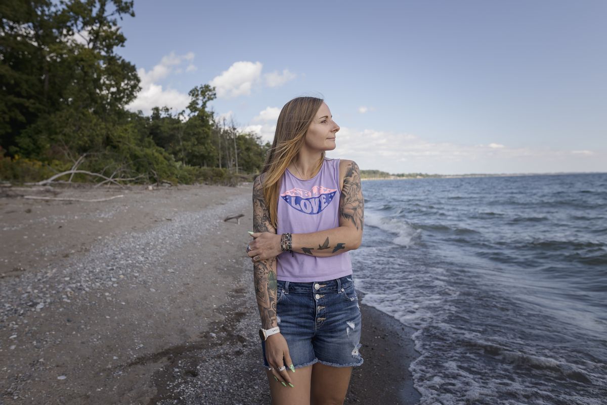 Kim Prosser walks along Lake Erie, thinking about her late son, Ashtyn, who died by suicide at 19, in Wheatley, Ontario, Canada on Sept. 15. Prosser believes her son sought out online forums to access the substance he used in his death; Canadian police have charged one man with assisting 14 suicides, a count that may grow.  (tara walton)