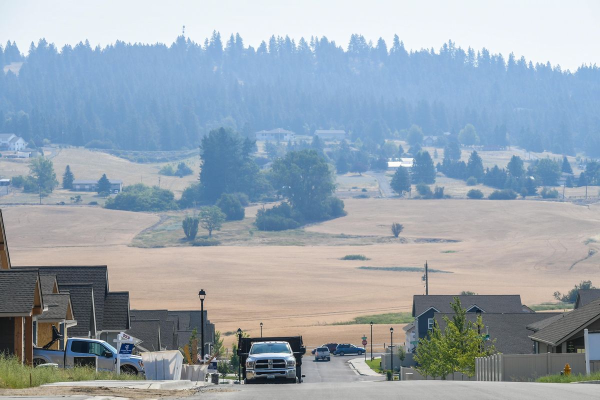 Neighbors along Glenrose Road saw the hillsides partially obscured by wild fire smoke, Wednesday, July 14, 2021, in Spokane.  (Dan Pelle/THE SPOKESMAN-REVIEW)