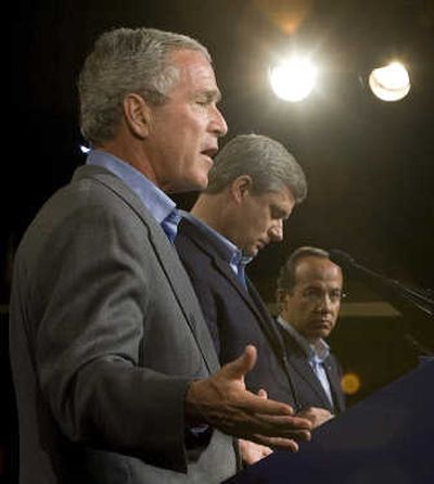 
President Bush answers questions during a news conference with Canadian Prime Minister Stephen Harper, center, and Mexican President Felipe Calderon at the close of the North American leaders summit on Tuesday. Associated Press
 (Associated Press / The Spokesman-Review)