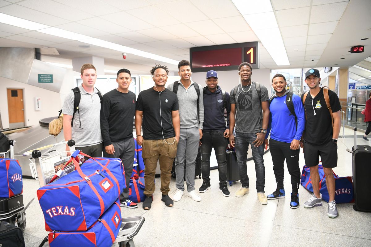 The first group of Spokane Indians players  arrives in Spokane  Saturday  at Spokane International Airport. They are, from left, Sam Hellinger, Florencio Serrano, Maxwell Morales, Luis Asuncion, Stanley Martinez, Starling Joseph, Cristian Inoa and Jayce Easley. (Jesse Tinsley / The Spokesman-Review)
