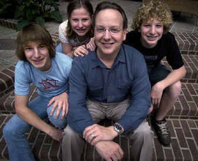 
David Smith enjoys the afternoon with his son Kodi, 4, in their Spokane Valley back yard. Below: Wayne Williams, center, is very involved in the lives of his children (left to right) Mitch, 17, Shayla, 10, and Spencer, 13. 
 (Brian Plonka / The Spokesman-Review)