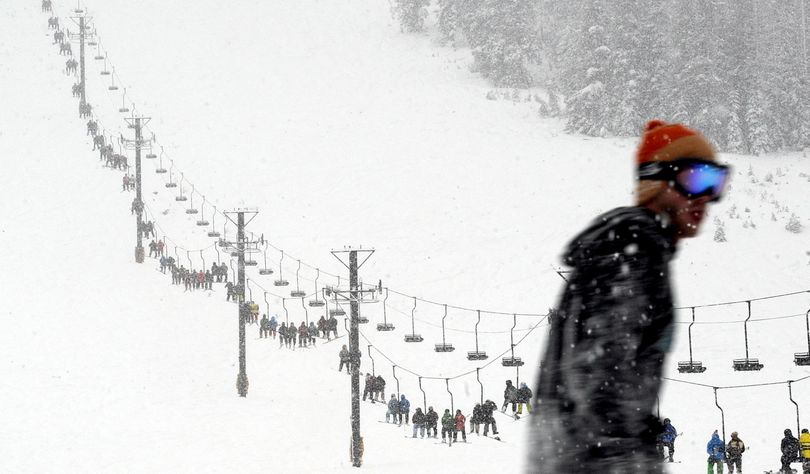 Skiers and snowboarders pack the lift during opening day at Lookout Pass Ski and Recreation Area on Friday. (Kathy Plonka)