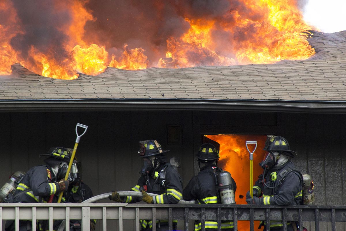 Firefighters fight an apartment blaze in which a man and woman  died Wednesday afternoon in north Spokane. The two-alarm fire started around 4 p.m. at the Rosewood Club apartments at 401 E. Magnesium Road, Assistant Fire Chief Brian Schaeffer said. (Allie Raye)