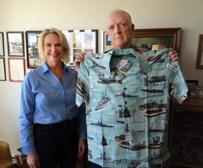 Bill McChristian, with Susan Meyer, the STA’s CEO, holds up a new shirt Meyer bought for him, in addition to $100 the STA gave McChristian to compensate him for his ruined attire. (Doug Clark)