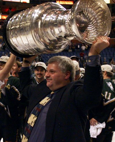 Dallas Stars coach Ken Hitchcock hoists the Stanley Cup after the Stars defeated the Buffalo Sabres 2-1 in triple overtime in Game 6 of the 1999 Stanley Cup finals in Buffalo, N.Y. Hitchcock is retiring, ending a 22-year career as the third-winningest coach in NHL history. (Ryan Remiorz / Associated Press)