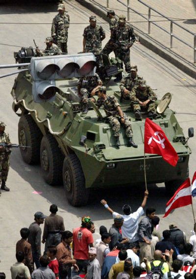 
Opposition party supporters wave party flags in front of an armored vehicle during a protest in Nepal on Friday. 
 (Associated Press / The Spokesman-Review)