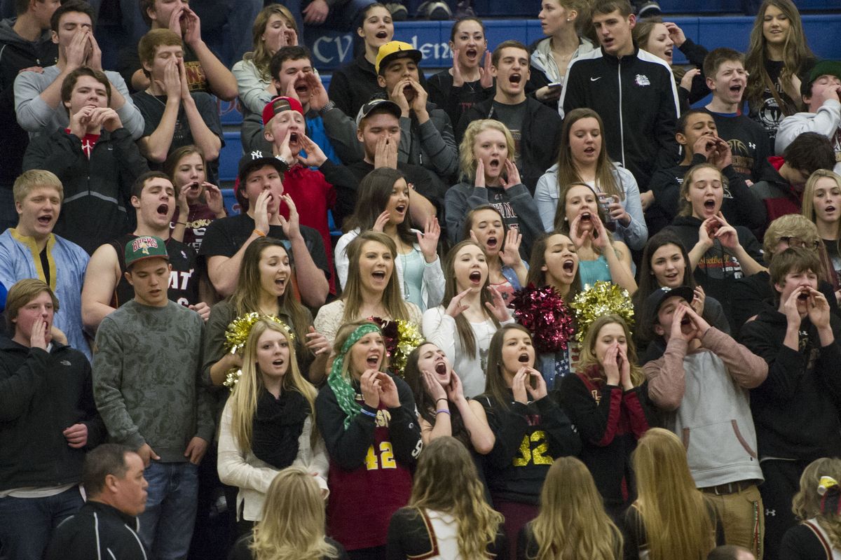 Above: Fans cheer Titans during 3A Regional against Kennedy Catholic. Right: U-Hi’s Ben Kuiper shoots over AJ McGrew.