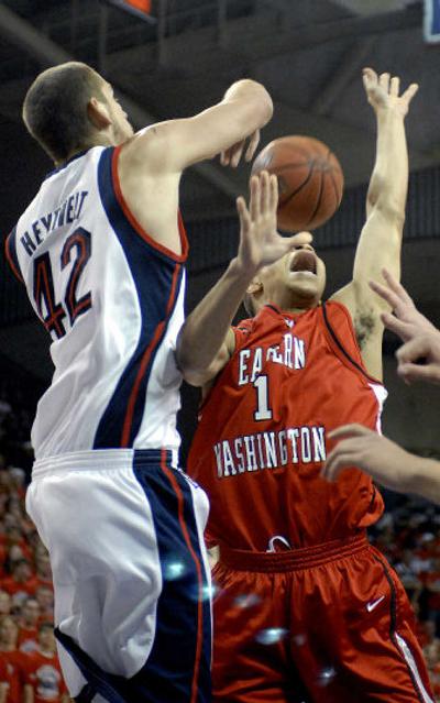 
Zags' Josh Heytvelt rejects a shot by Eagles' Marcus Hinton. Heytvelt scored a game-high 22 points. 
 (Dan Pelle / The Spokesman-Review)