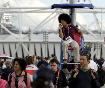 A worker directs the crowd at Olympic Park during the 2012 Summer Olympics in London. Chairs such as the one used here for crowd control are among the more than 1 million items on sale from the athletes village and Olympics Park. The items will be ready for collection right after the Paralympic Games end in early September. (Associated Press)