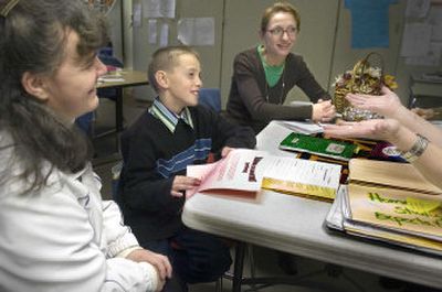 
Vera Puzankova, in the green shirt,  listens and helps translate Monday  as Whitman Elementary School fifth-grader Paul Malko  sits in during a  conference with his mother, Ivanna,  left, and Whitman teacher Renee Swecker. Puzankova translates for parents of Russian and Ukrainian students. 
 (CHRISTOPHER ANDERSON / The Spokesman-Review)