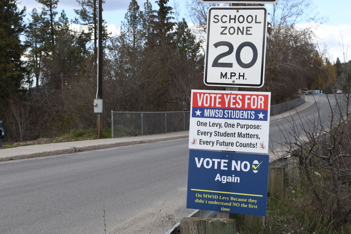Campaign signs for and against the Mary Walker School District levy compete alongside each other near the school campus in Springdale, Wash. (James Hanlon/The Spokesman-Review)