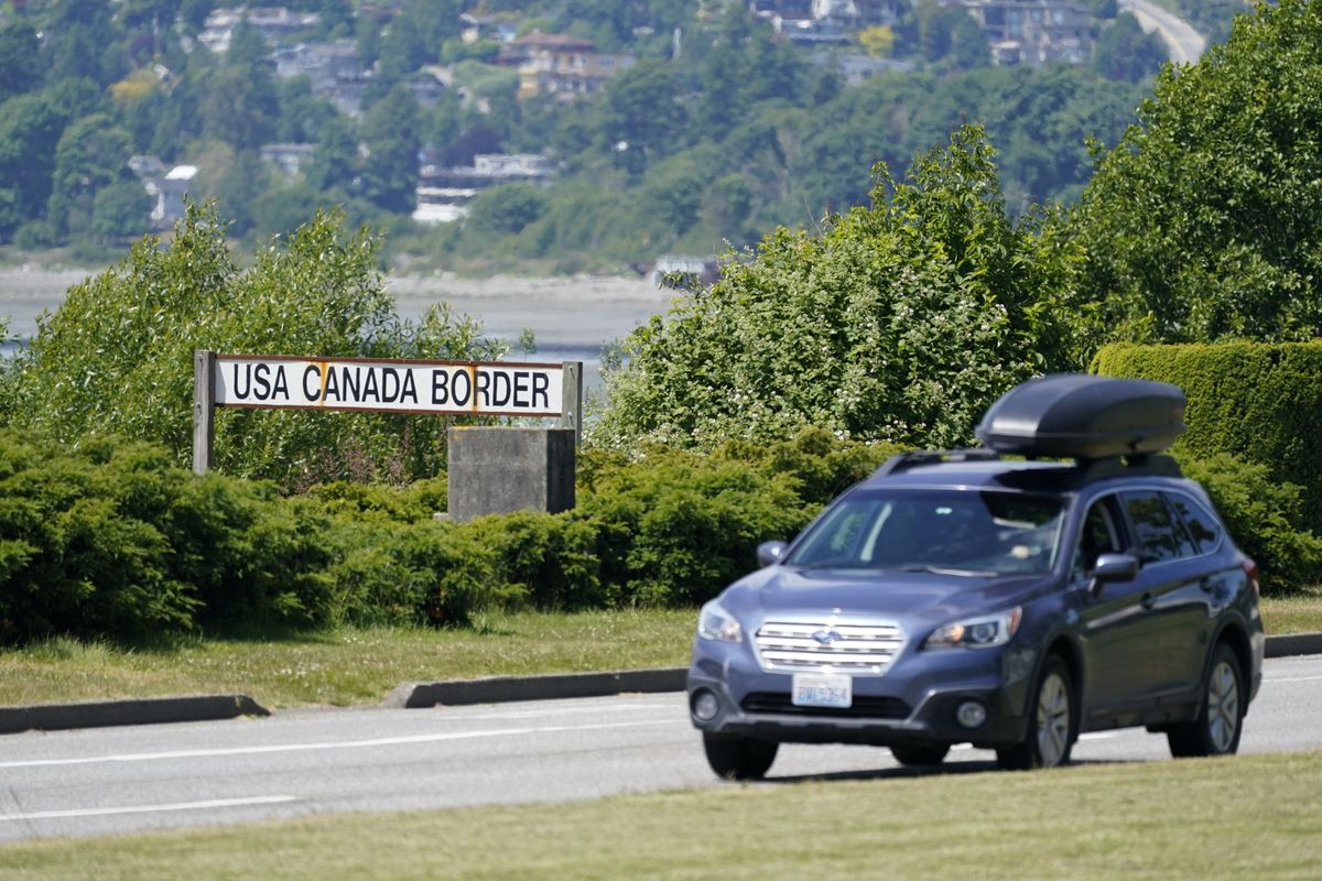 FILE - In this June 8, 2021, file photo, a car heads into the U.S. from Canada at the Peace Arch border crossing in Blaine, Wash. Canada is lifting its prohibition Monday, Aug. 9, on Americans crossing the border to shop, vacation or visit, but the United States is keeping similar restrictions in place for Canadians. The reopening Monday is part of a bumpy return to normalcy from COVID-19 travel bans.  (Elaine Thompson)