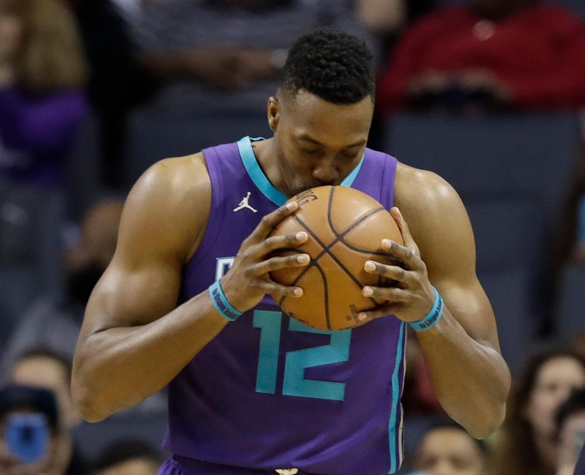 Dwight Howard  kisses the basketball before the start of a game against the Indiana Pacers in Charlotte, N.C. (Chuck Burton / AP)
