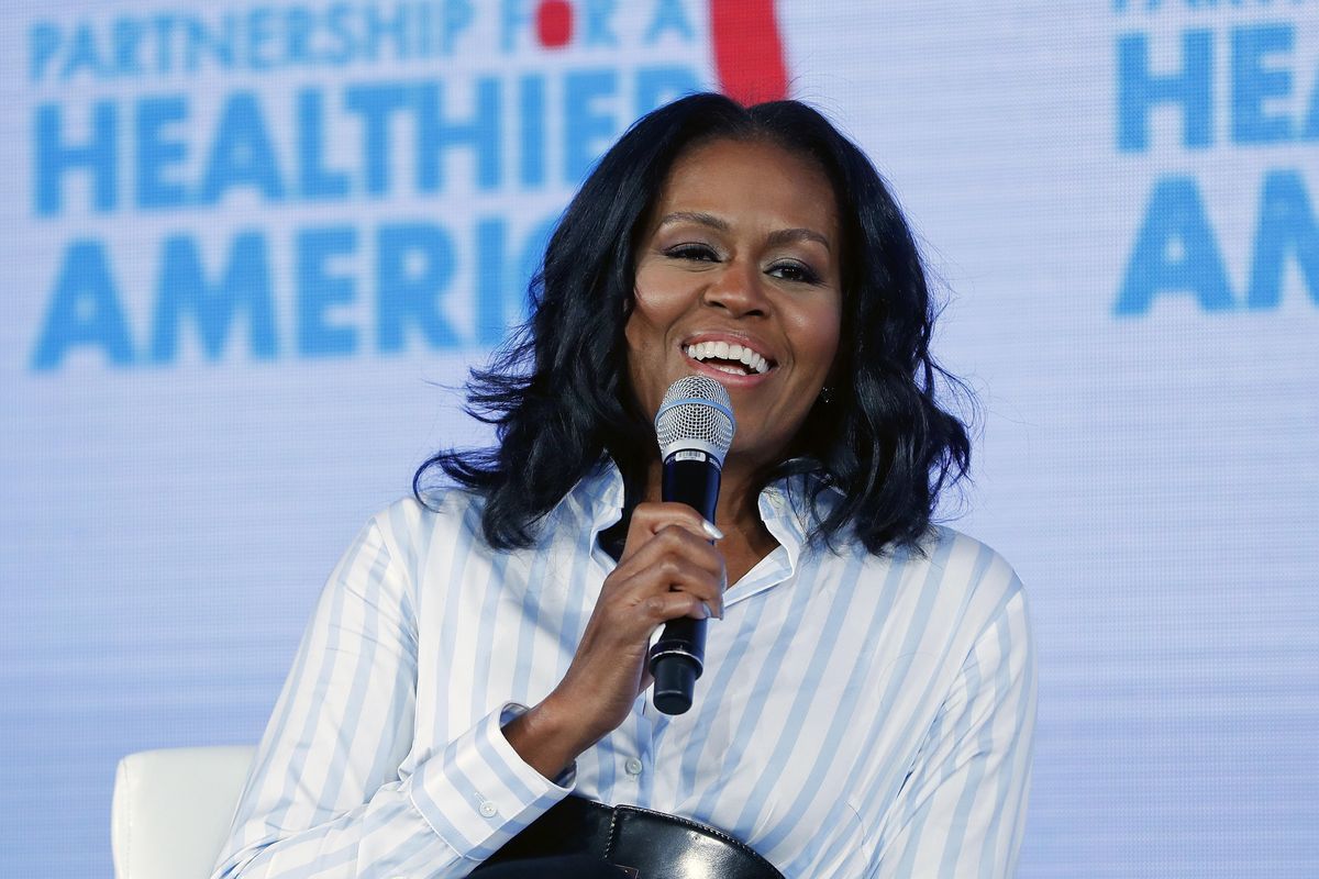 In this May 12, 2017, file photo, former first lady Michelle Obama smiles while speaking at the Partnership for a Healthier American 2017 Healthier Future Summit in Washington. The former first lady tweeted Sunday, Feb. 25, 2018 that her memoir, one of the most highly anticipated books in recent years, is coming out Nov. 13, 2018, and is called “Becoming.” (Pablo Martinez Monsivais / Associated Press)