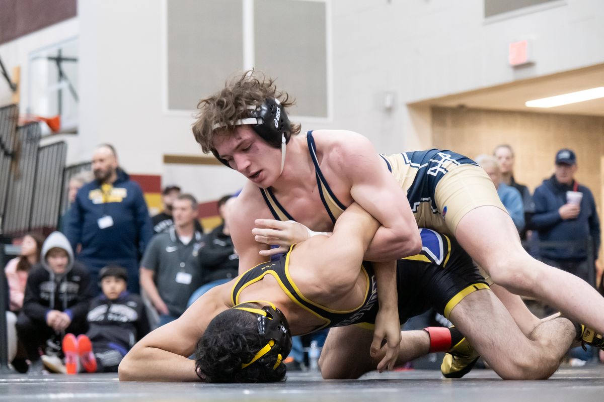Mead’s Josh Neiwert, top, looks to turn and pin Isaac Ramirez Ruiz of Hermiston, Oregon, during the Region 4 3A state-qualifying tournament Saturday at University High.  (Madison McCord/For The Spokesman-Review)