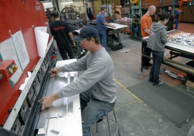 
Joe Ranney performs press break forming on a machine near the optical assembly at Ecolite Manufacturing in teh Spokane Valley.
 (Dan Pelle / The Spokesman-Review)