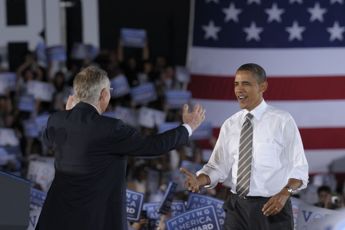 Senate Majority Leader Harry Reid greets President Barack Obama at a rally in Las Vegas on Friday.  (Associated Press)