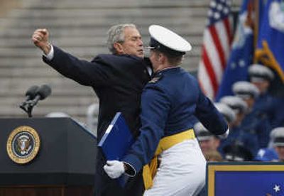 
President Bush bumps chests with Air Force Academy graduate Theodore Shiveley, from Plano, Texas, during the Air Force Academy graduation ceremony Wednesday. Associated Press
 (Associated Press / The Spokesman-Review)