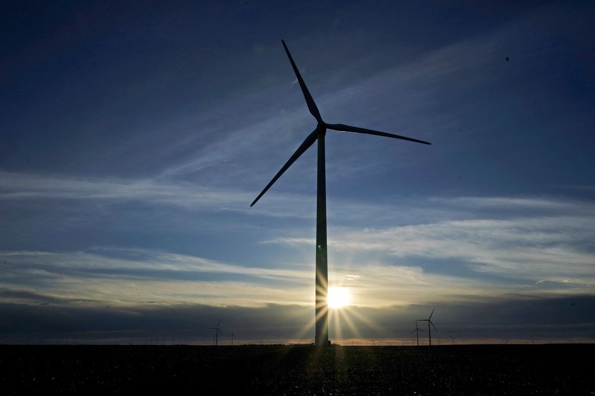 A wind turbine is silhouetted against the rising sun on Jan. 13 near Spearville, Kan.  (Charlie Riedel)